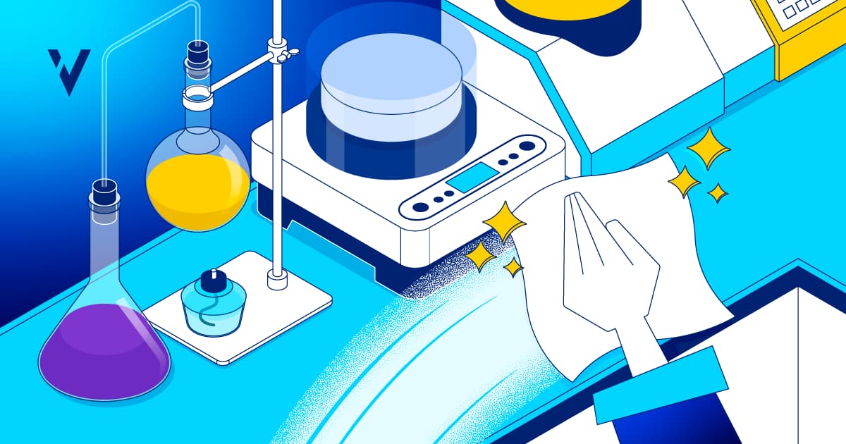 An isometric illustration of a clean laboratory workspace. A hand wipes down a white countertop next to lab equipment, including a hot plate, flasks, and a magnetic stirrer.